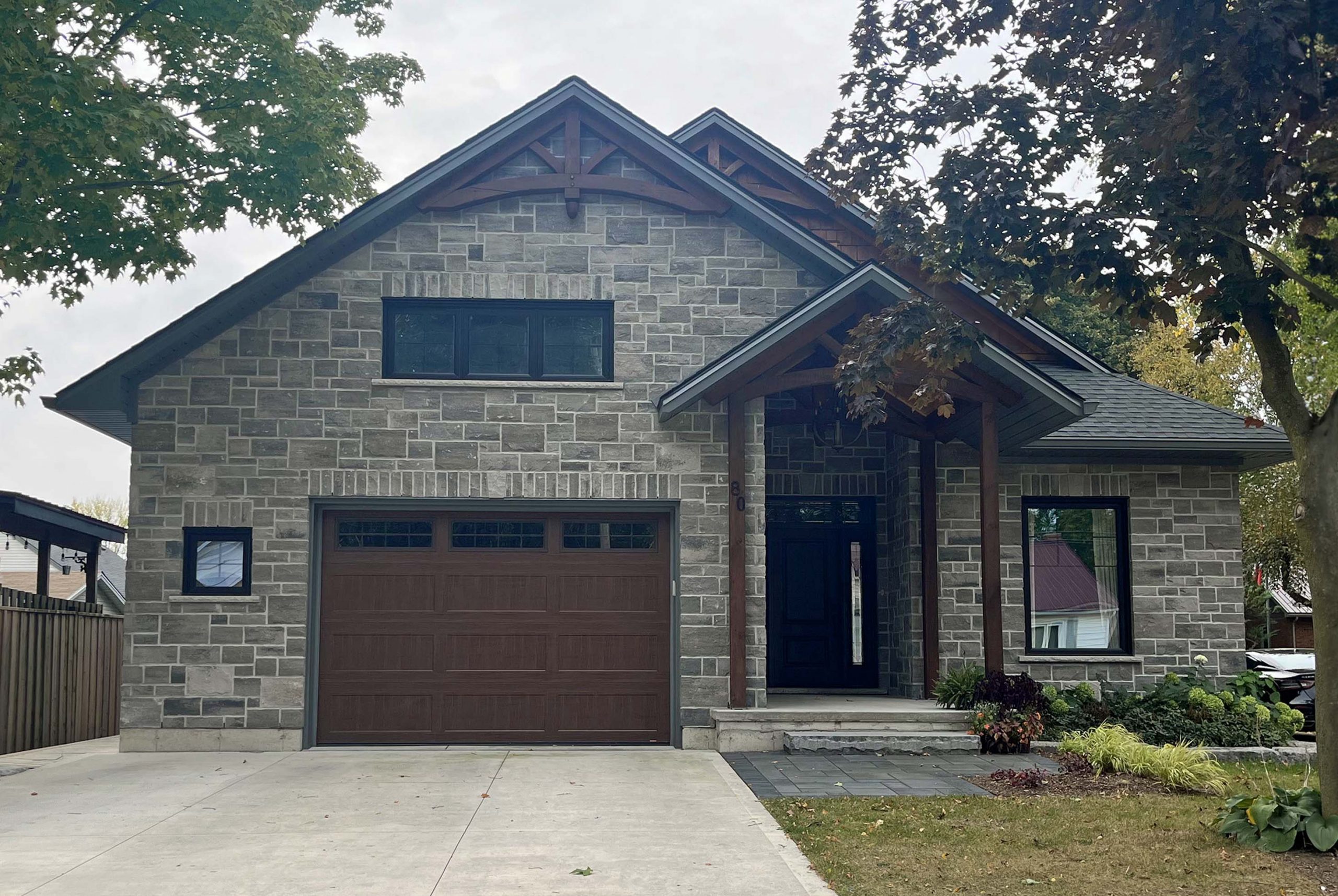 80 South St. W. A home composed of grey cobblestone and intricate timberwork.