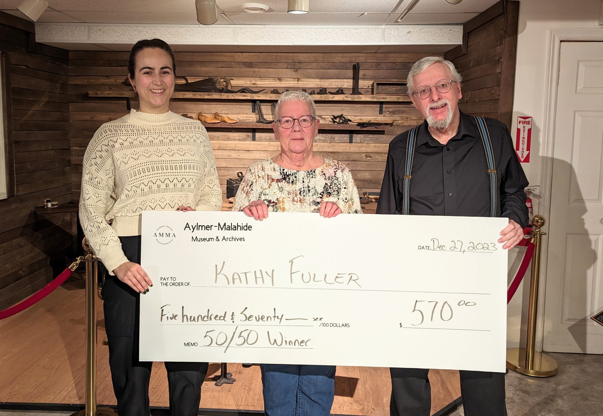 Three people and a presentation cheque